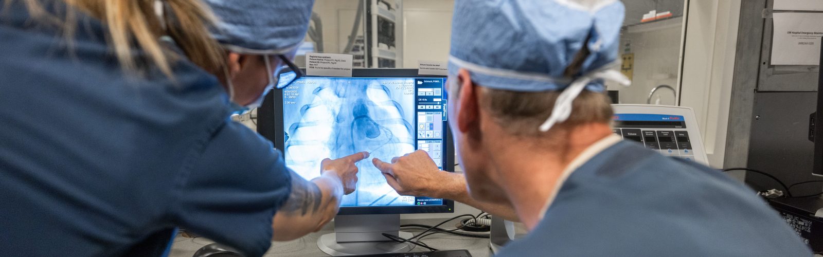 researchers looking at images of the heart